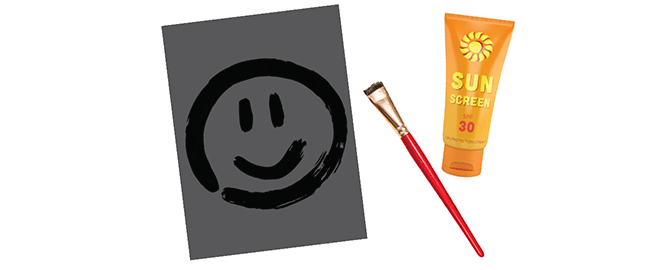 Sunscreen and a paint brush on paper