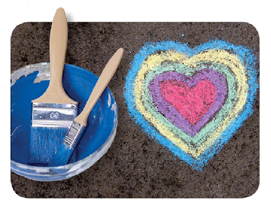 A painted heart next to a bucket of paint with paintbrushes in it