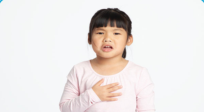 a girl with a hand placed across her chest